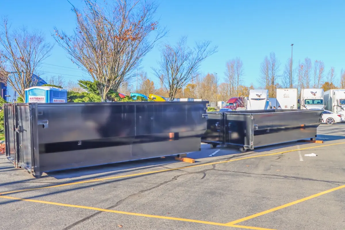 Professional dumpster rental service with roll-off container on residential driveway in Swartz Creek